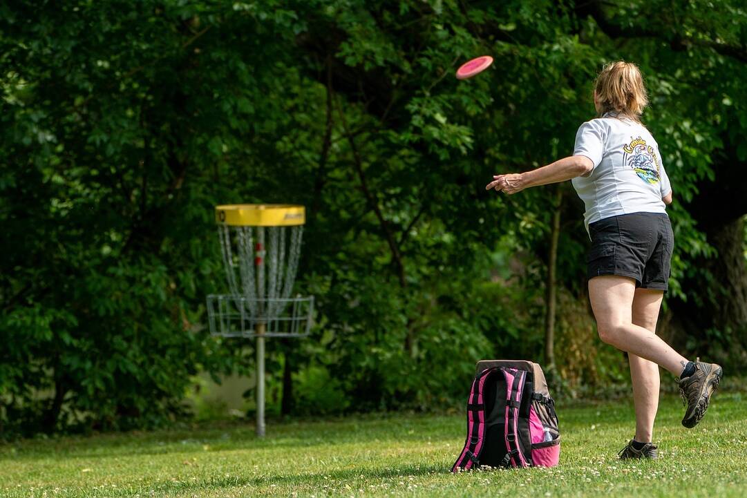 Girl playing disc golf