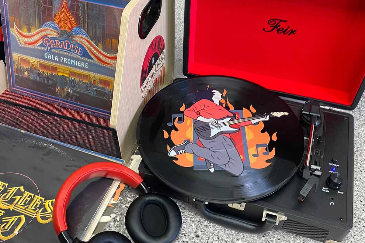 Vinyl record on player with printed man with guitar on record